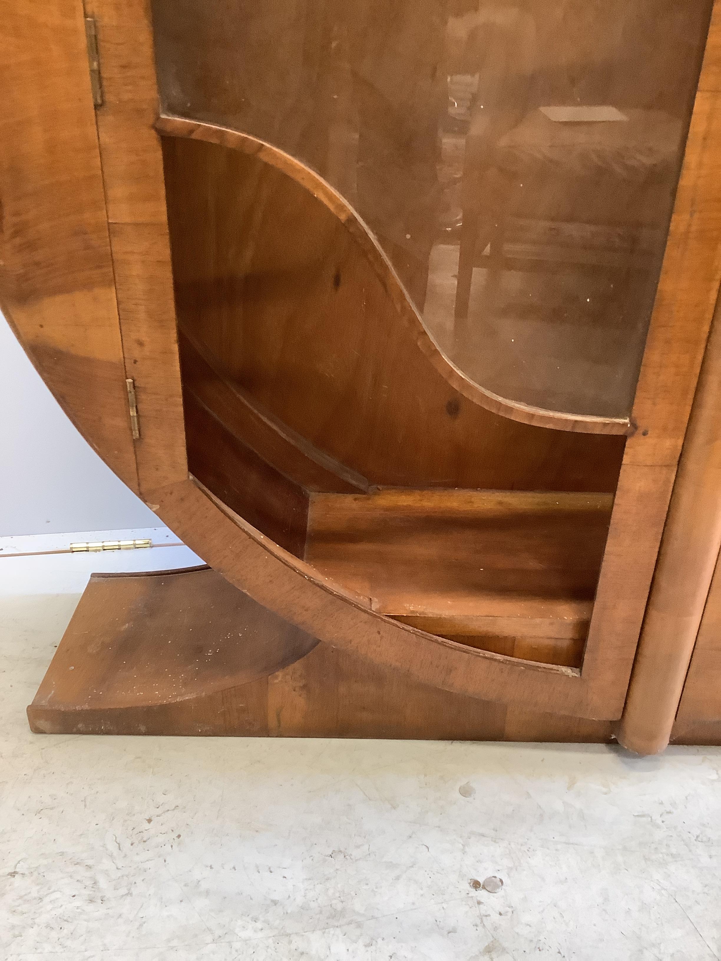 An Art Deco circular walnut veneered display cabinet, width 126cm, depth 30cm, height 125cm